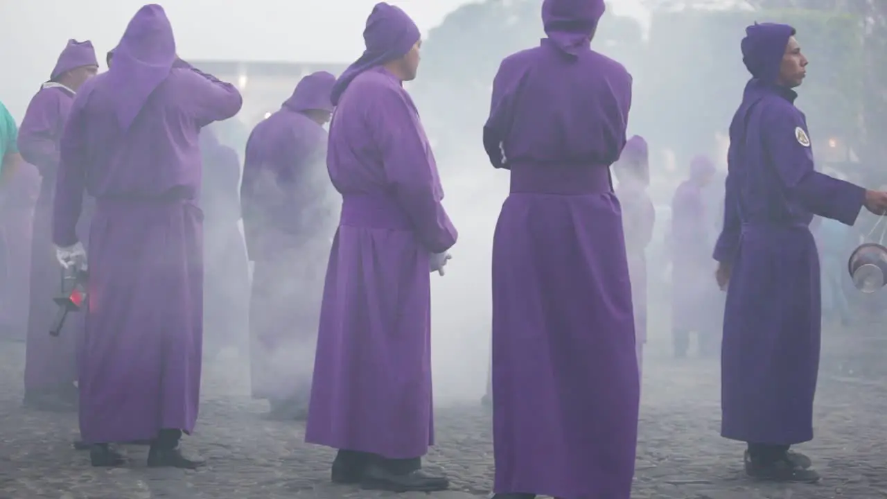 Purple robed Catholic Christian priests march in the Semana Santa Easter week holidays in Antigua Guatemala 4