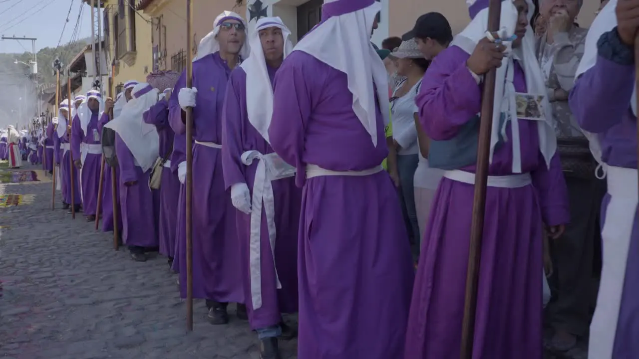 Purple robed Catholic Christian priests march in the Semana Santa Easter week holidays in Antigua Guatemala