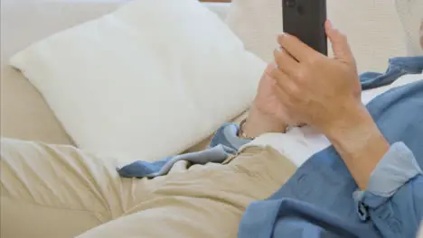 Sliding Shot of Middle Aged Man Scrolling On His Smartphone