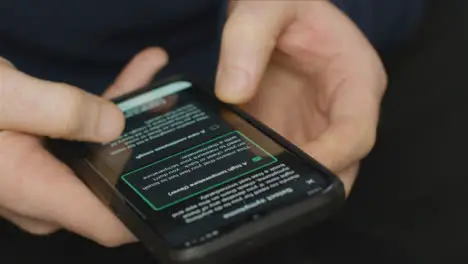 Close Up of Hands Using COVID 19 Lockdown Smartphone Application