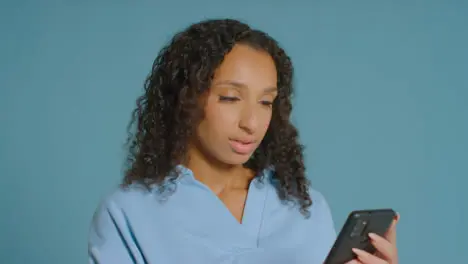 Portrait Shot of Young Adult Woman Using a Smartphone