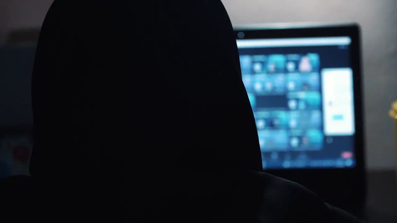 Slow Motion Head a woman wear veil doing group zoom meeting with hand on the laptop keyboard