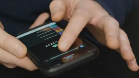 Close Up of Hands Using COVID Lockdown Smartphone Application