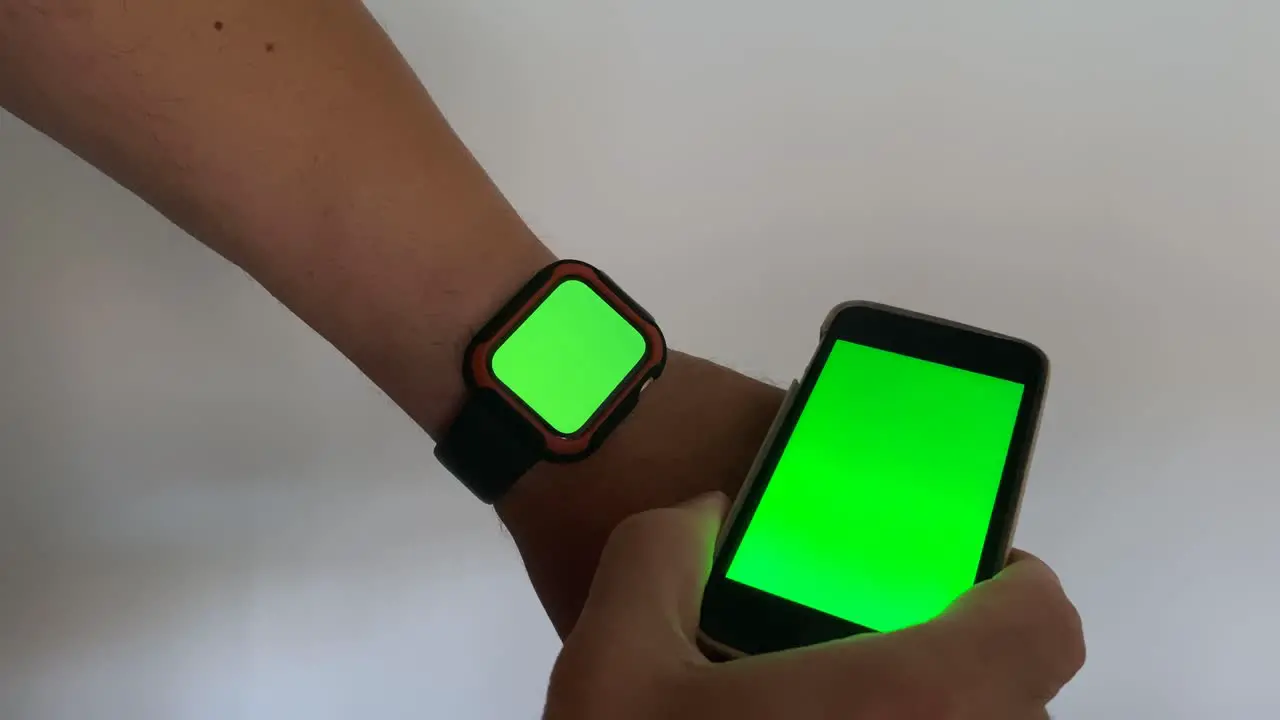 Man using smartwatch with chroma key close-up