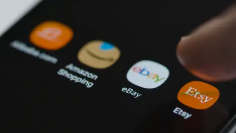 Close Up Shot of Finger Tapping the Etsy App On Smartphone