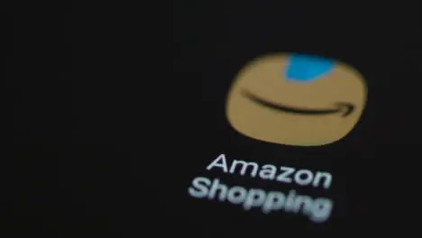 Close Up Shot of Finger Tapping the Amazon Shopping App On a Smartphone Screen