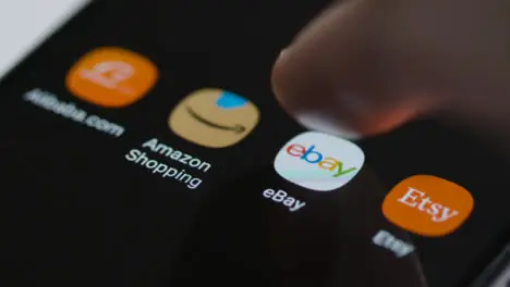 Close Up Shot of Finger Tapping the Ebay App On Smartphone