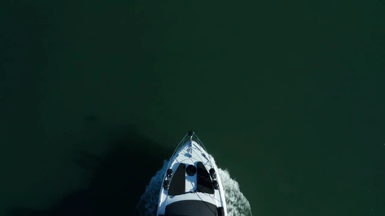 Top down pass over the Yacht as it rolls along the shoreline in the bay