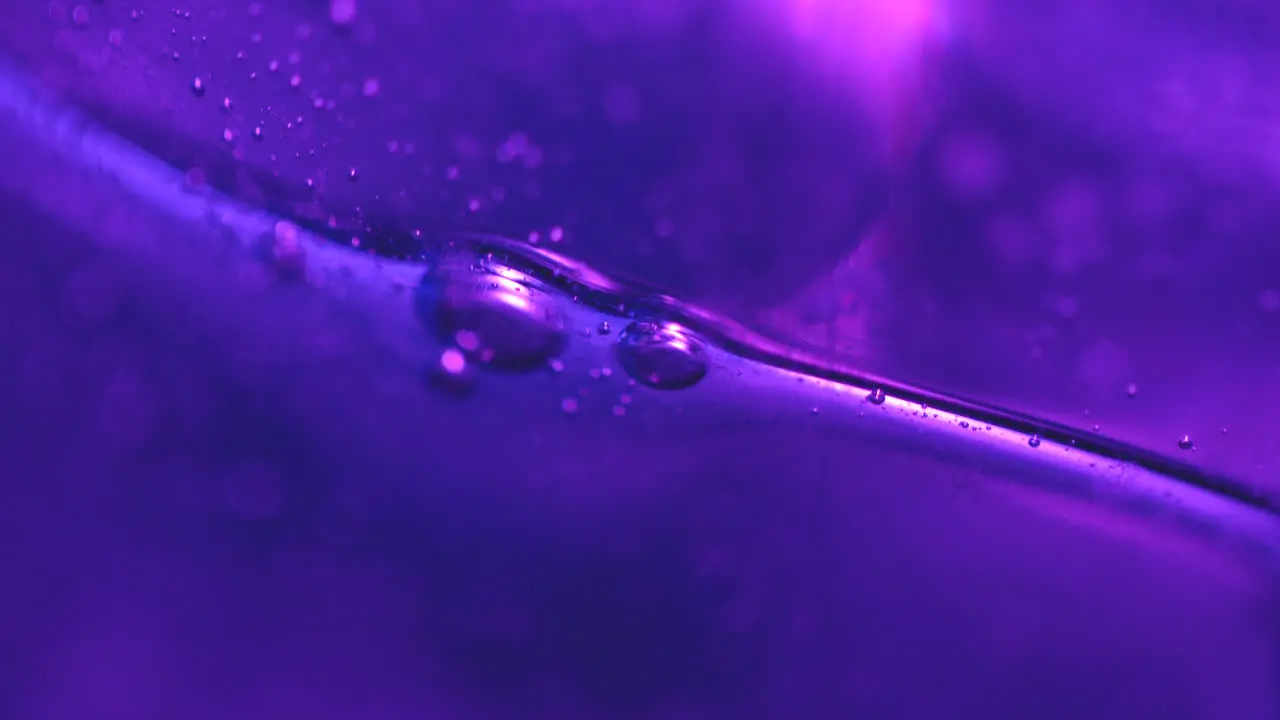 Slow Moving Purple Bubbles in Abstract Macro Background