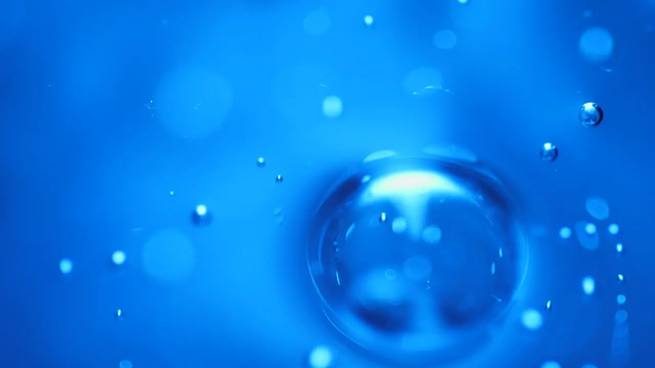 Blue abstract gas bubbles rising in liquid