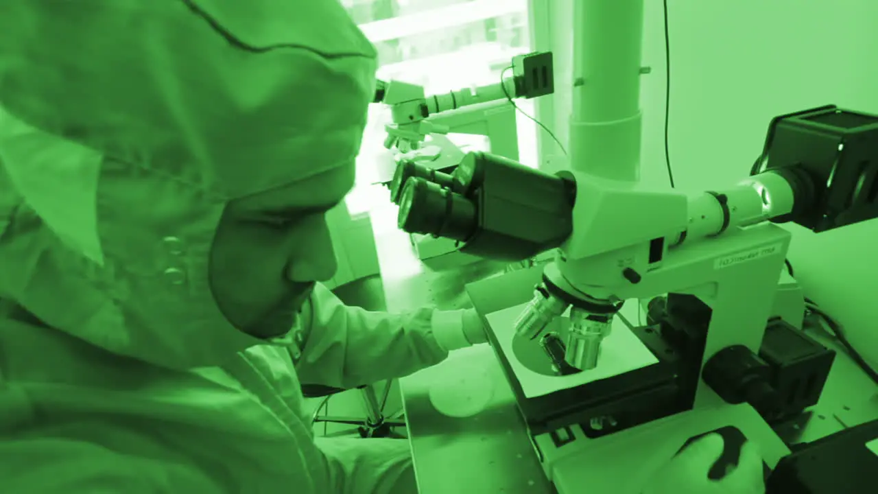 Laboratory Technician using Microscope at a Hazardous Lab