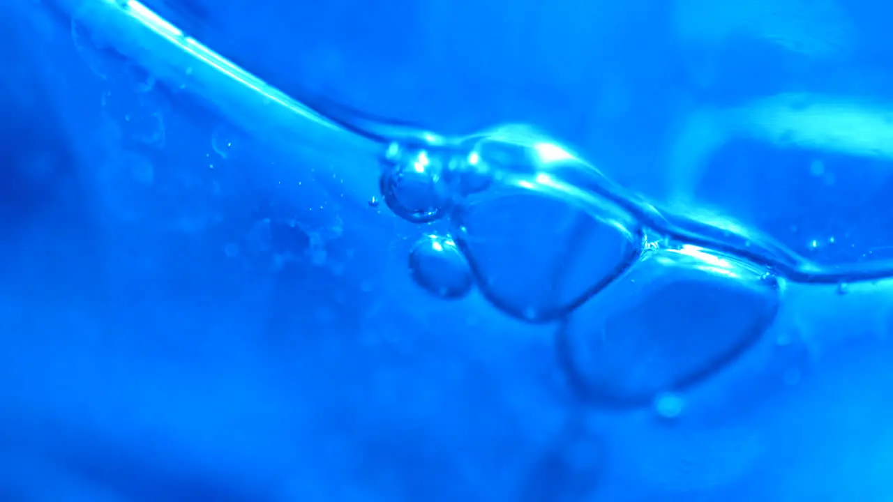 Slow Moving Blue Bubbles in Abstract Macro Background