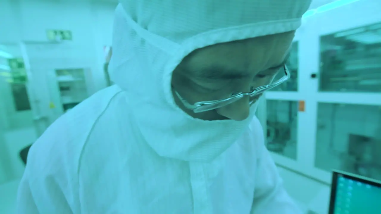 Chinese male scientist investigates results using tweezers in a lab