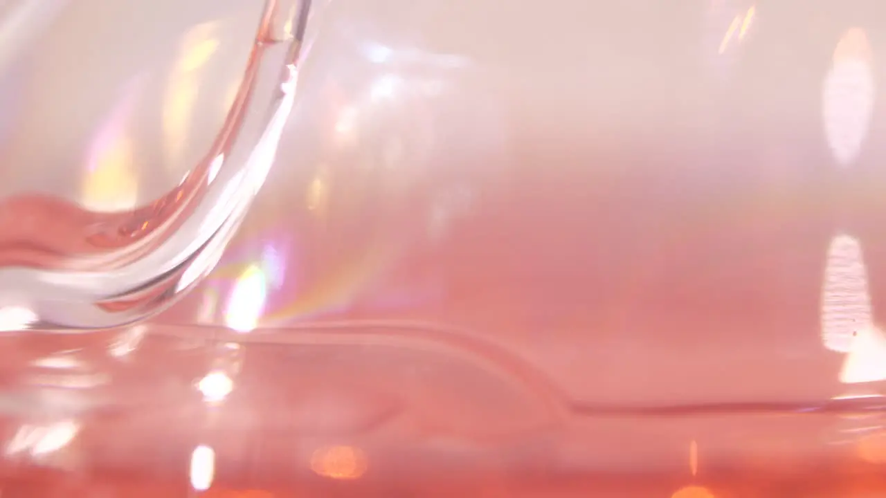 Macro shot of red liquid being spilled in laboratory slow motion