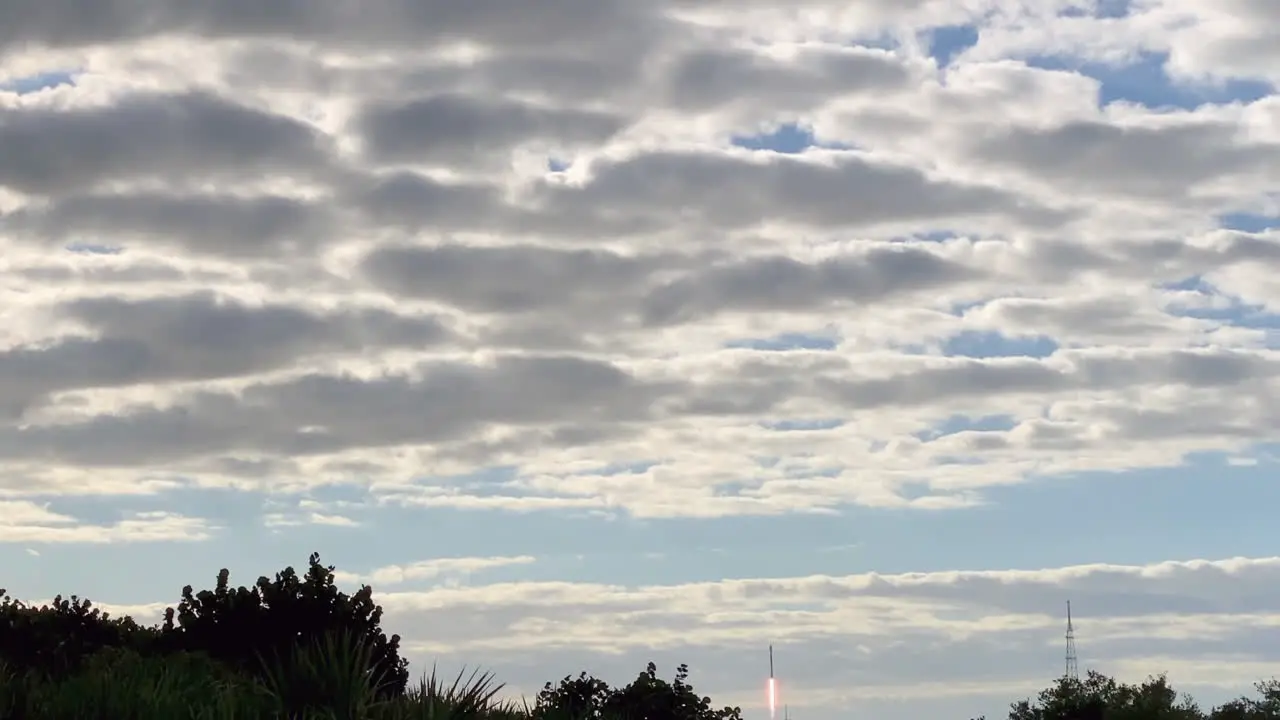 A view of a rocket taking off and flying into space through the clouds