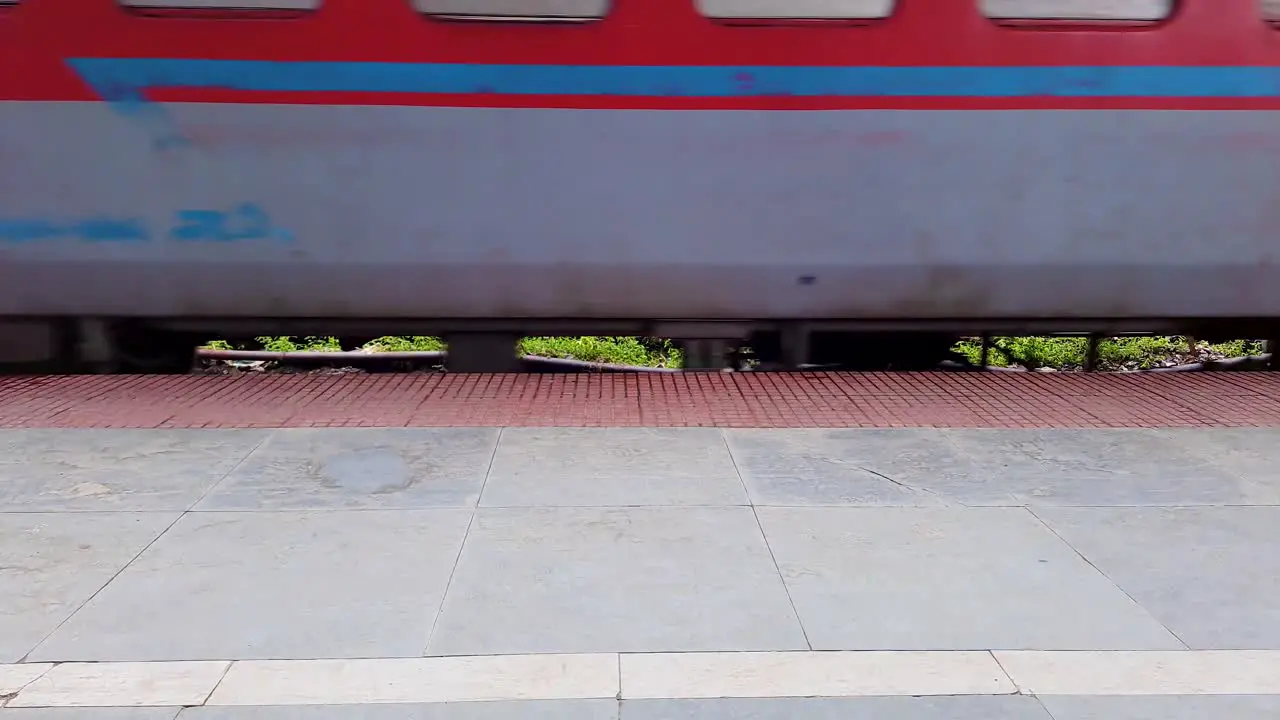 indian passenger express train crossing station on track at evening from flat angle video is taken at kamakhya railway station assam india on May 22 2022