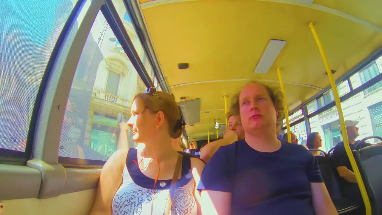 Tourist couple sitting in Italian bus during spring in t-shirt fisheye pov