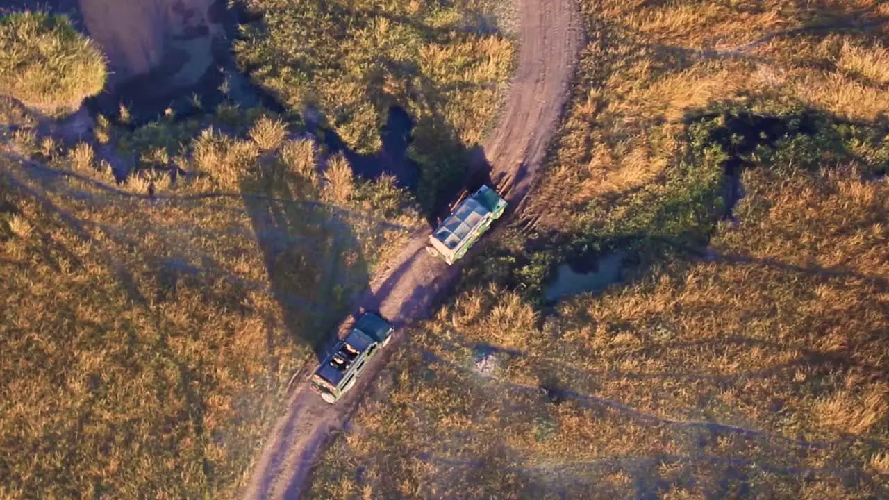 Safari Vehicles Driving Off-road In Kenya Africa On A Sunny Day