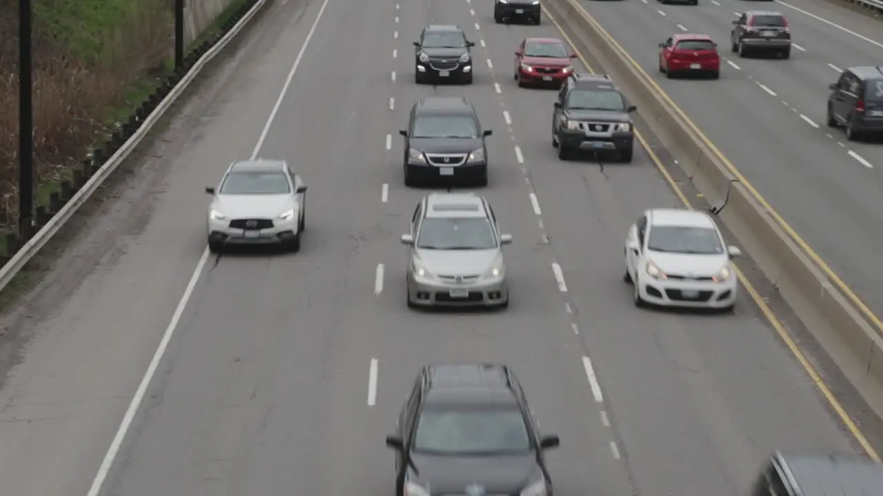 Cars on a highway moving under an overpass