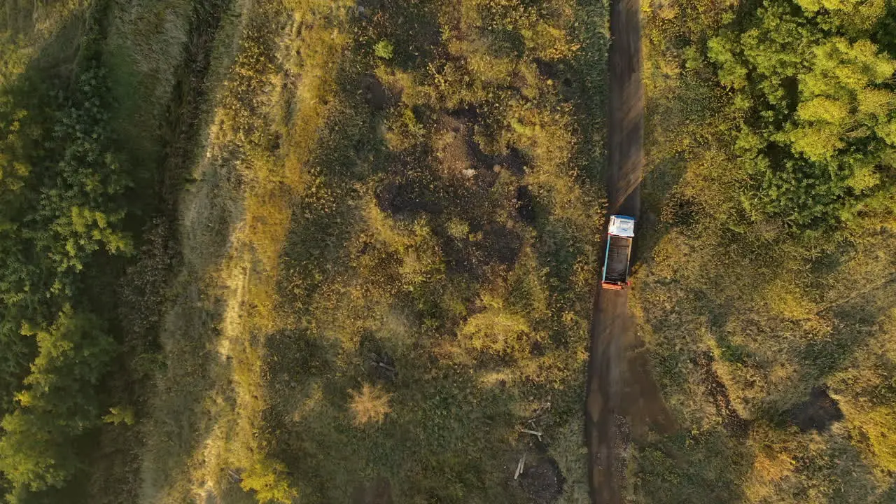 Steady drone shot of a trick driving dirt road