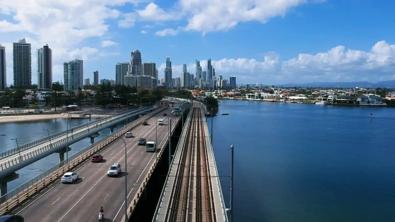 A bridge leading into a city over a large body of water