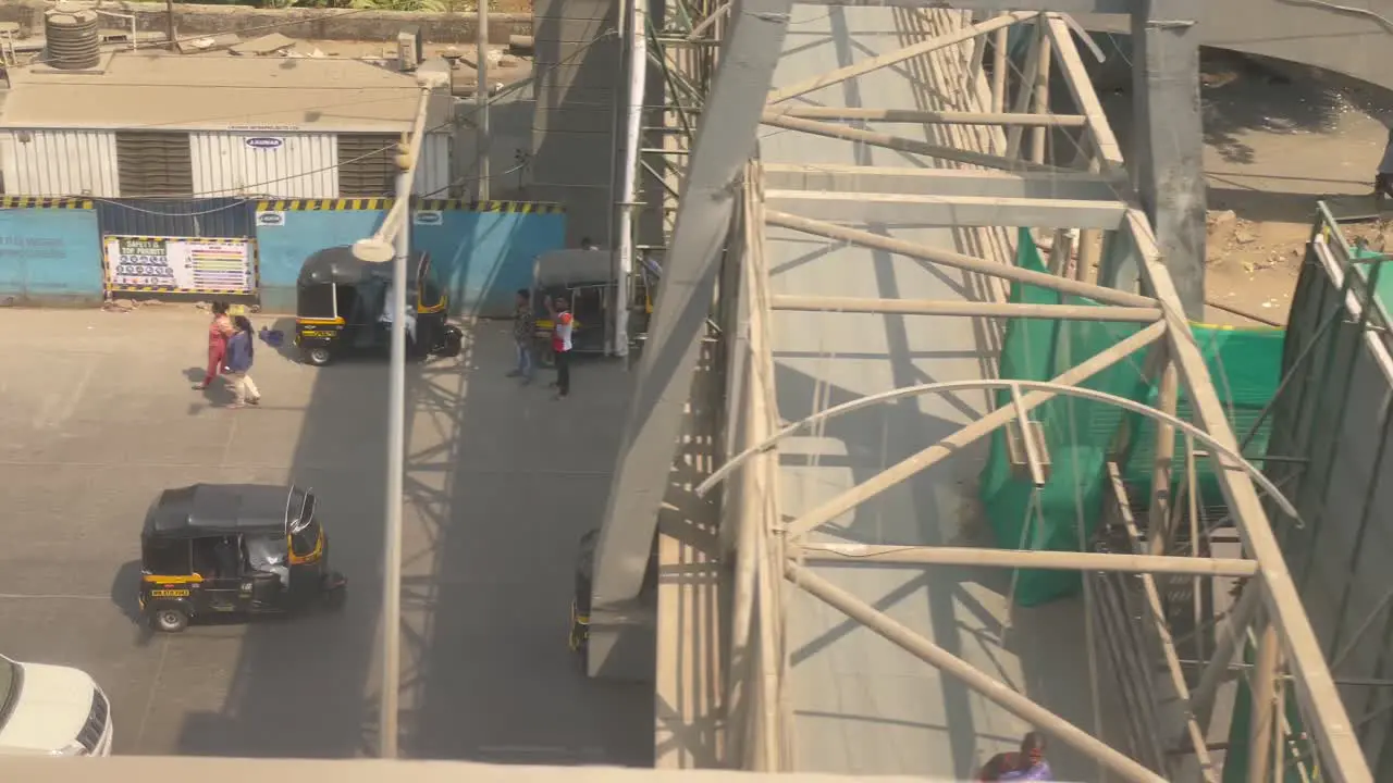 Traffic On Highway With Tuk Tuk Tricycles And Other Transport Vehicles Driving At Speed View From Moving Metro Train In Mumbai India