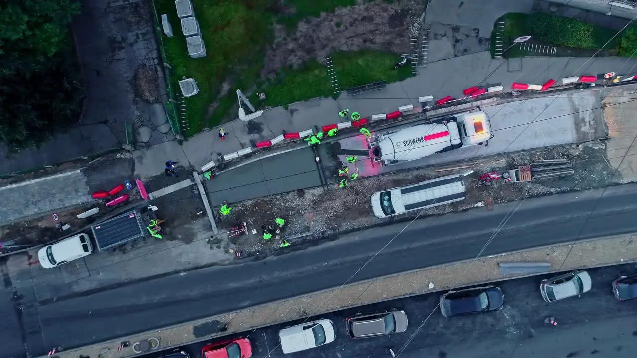 Aerial top down shot of construction site in city with truck and crane build of asphalt street