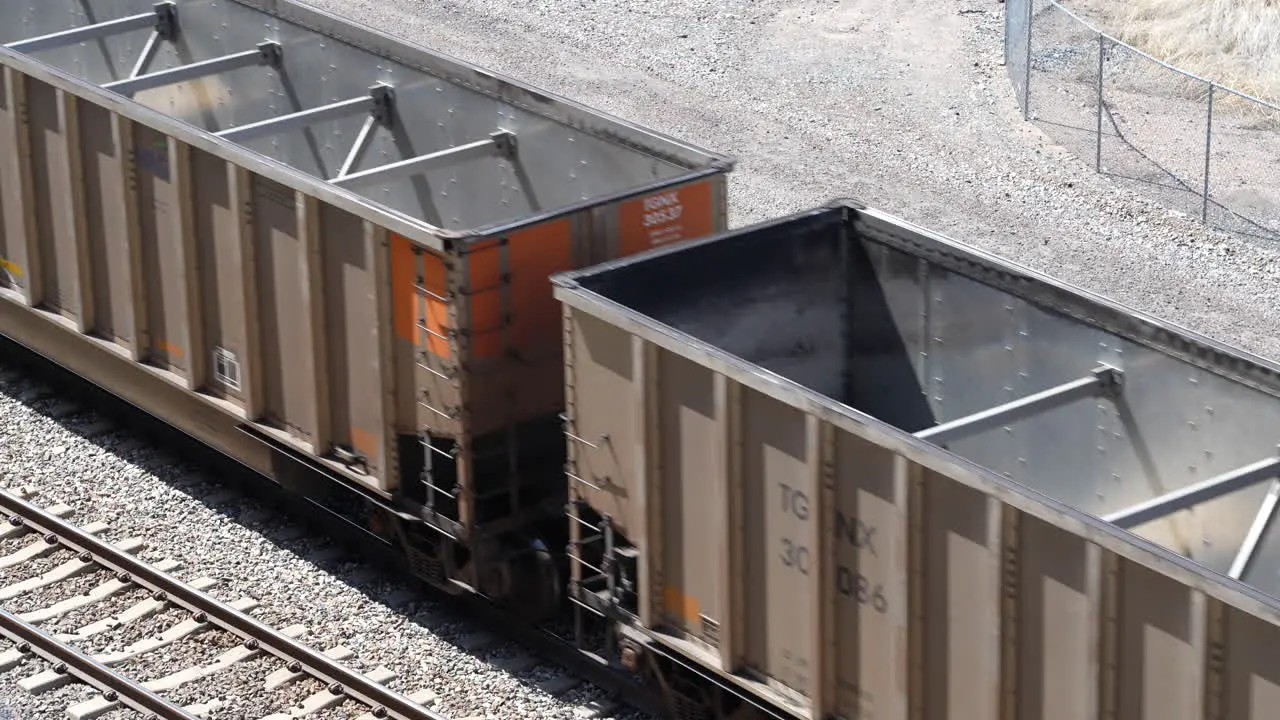 Empty hopper cars of freight transport train passing by