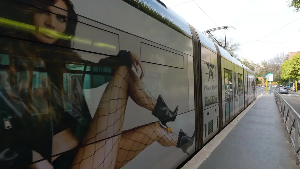 Tram Arrives at Public Transit Stop in Rome Italy