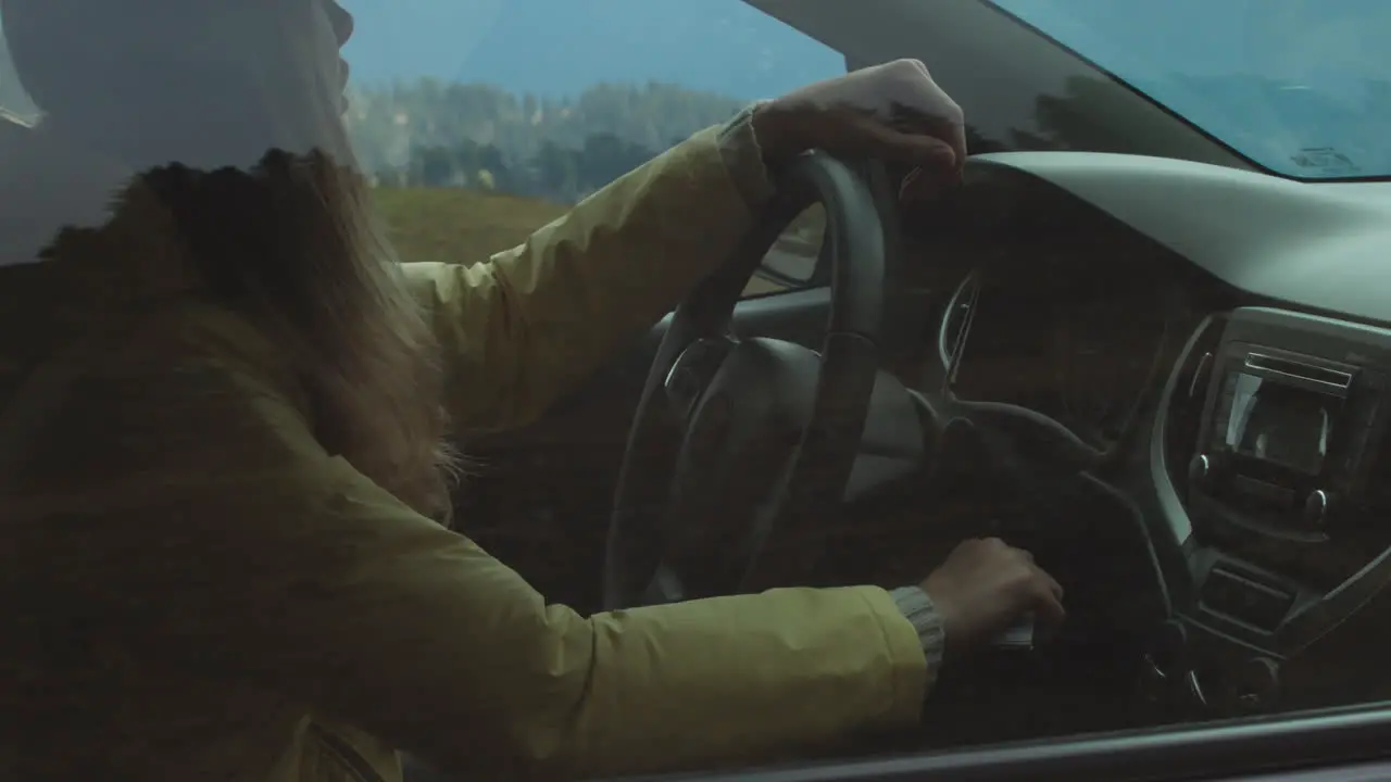 Woman Stopping Car in Mountains 02