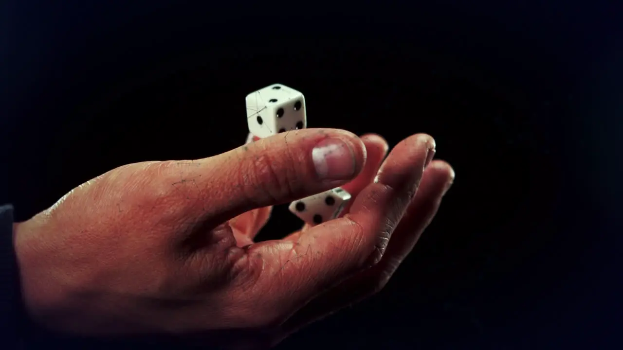 Animation of dice on hand over black background