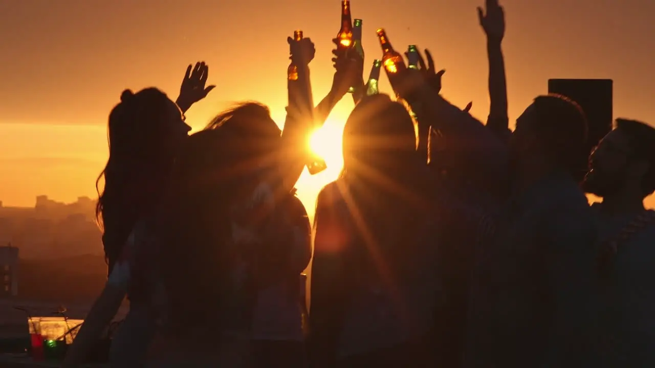 Group Of Friends Enjoying A Party On A Terrace At Sunset 1