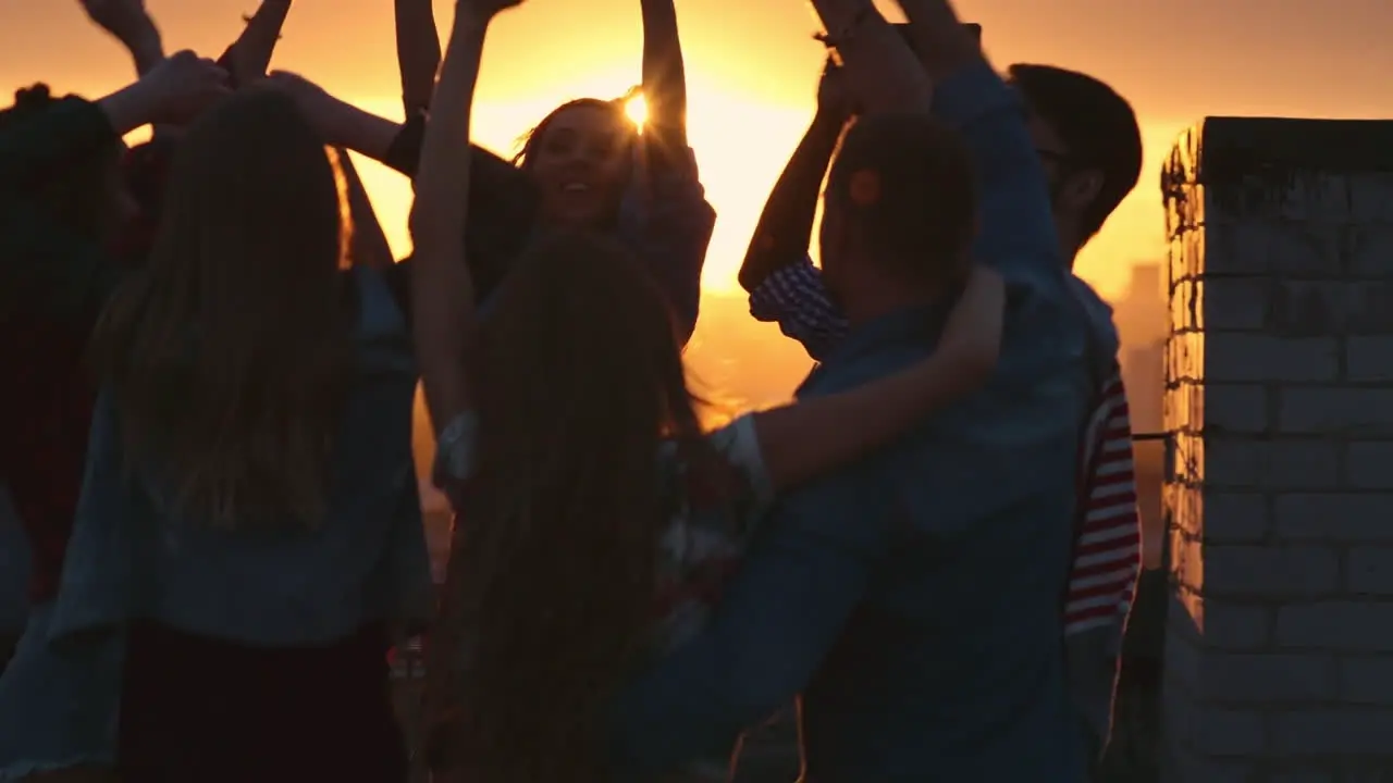 Group Of Friends Enjoying A Party On A Terrace At Sunset