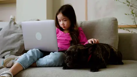 Girl petting dog at home