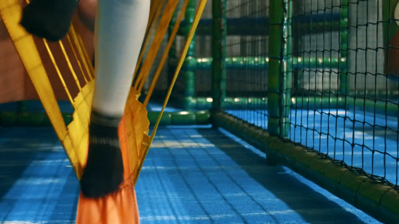 Children walking over wobbly attribute past the camera in a playhouse