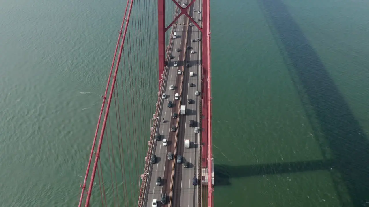 Aerial view of heavy traffic on multilane highway in rush hour Drone flying over big bridge spanning Tagus river Lisbon capital of Portugal