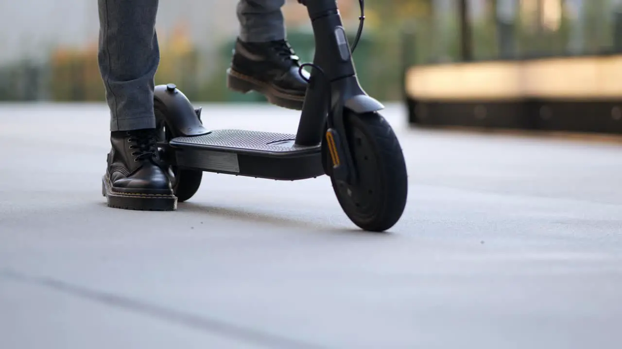 close up shot of an businessman arriving with his e scooter