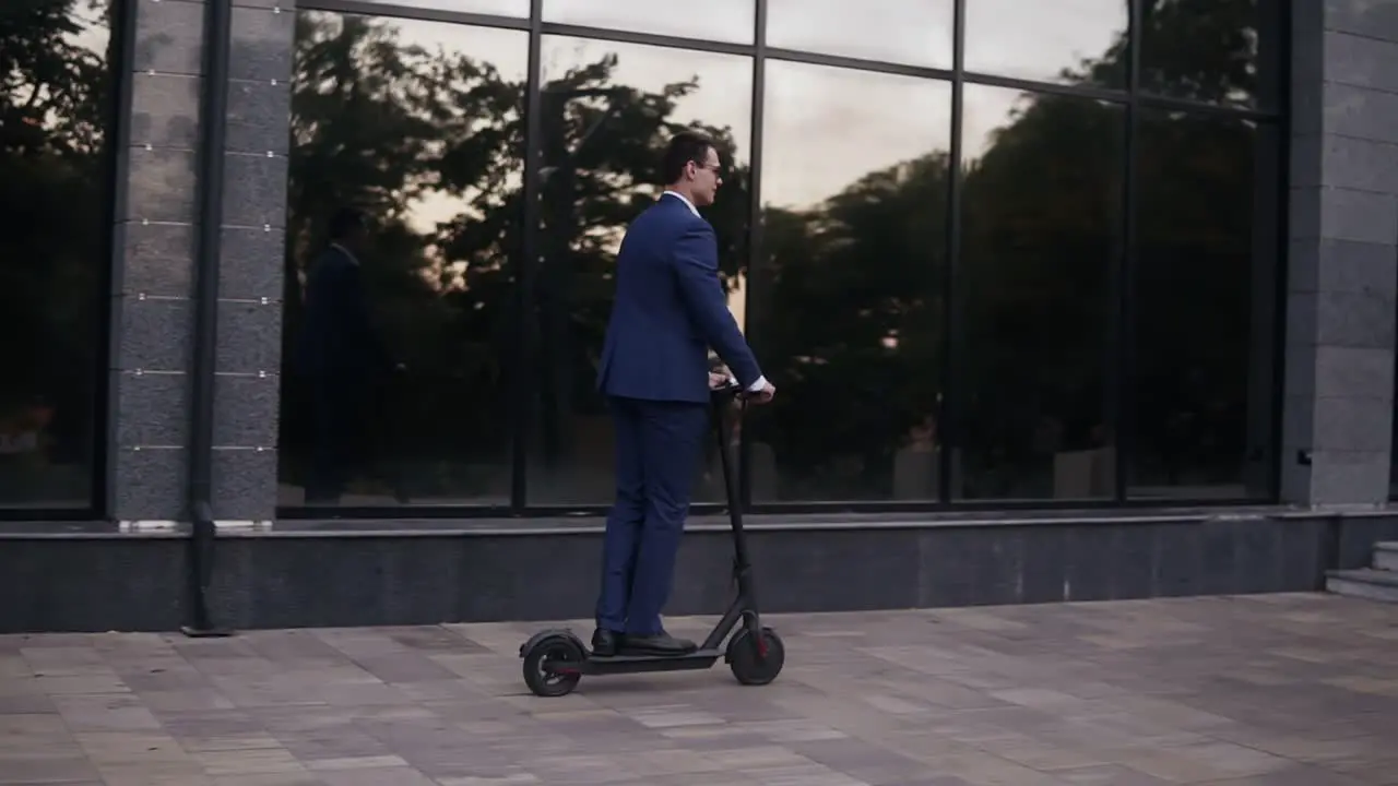 Young Businessman Riding An Electric Scooter For A Business Meeting In The Office Office Buildings Business Man Electric Transport Ecological Transport