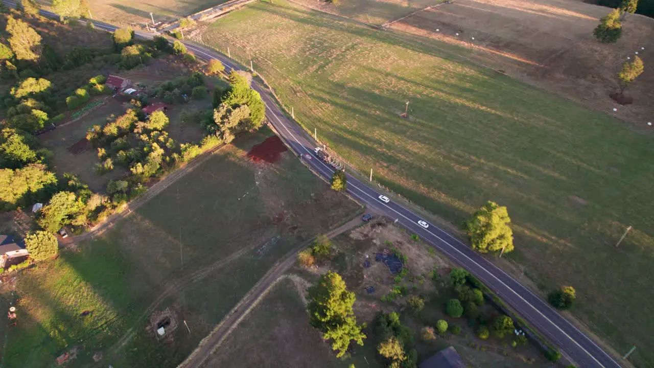 A truck transporting cargo through a scenic rural landscape