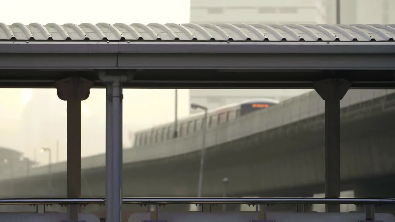 Train Seen Through Pillars of Footbridge