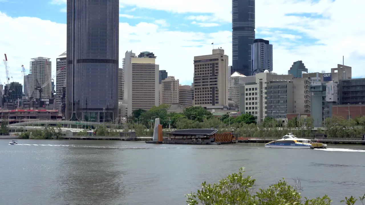 brisbane city hopper and citycat ferry passing across brisbane river in brisbane city near southbank during daytime