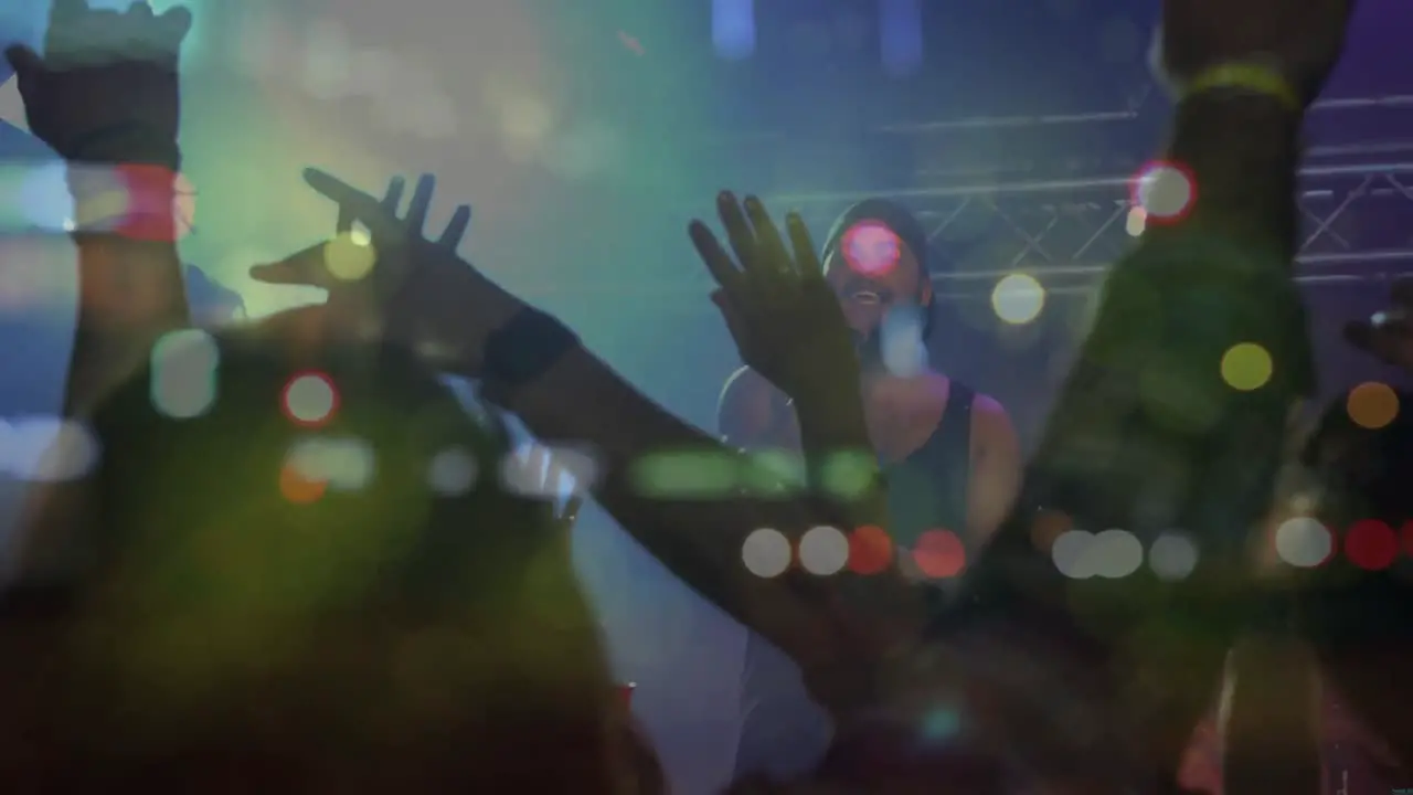 Animation of blurred road traffic over diverse people dancing at concert