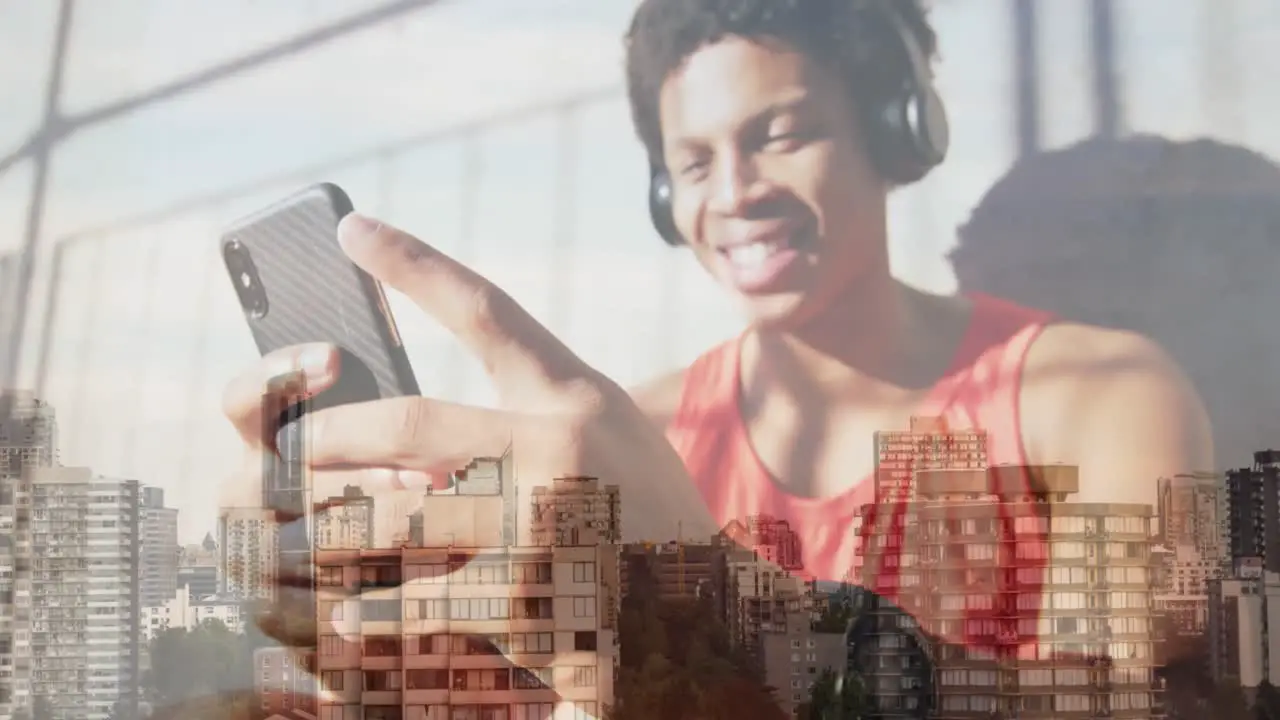 Animation of happy african american man wearing headphones over cityscape