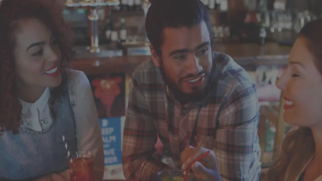 Animation of neon cocktail glasses flashing over smiling friends making toast in bar