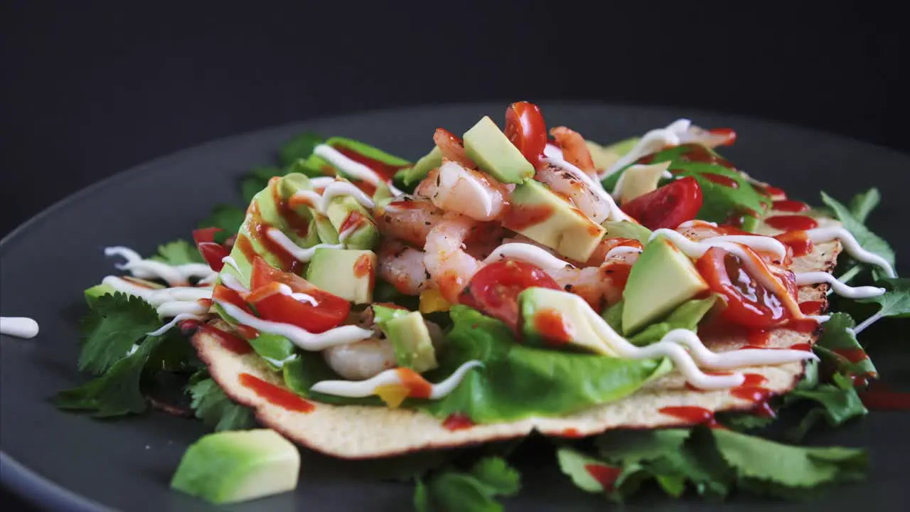 Freshly Prepared Flat Open Shrimp Taco rotating on black background 4k