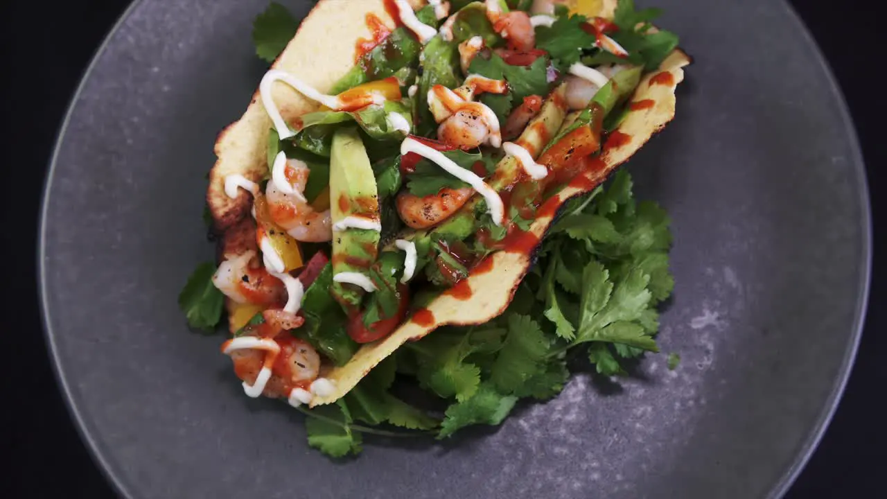 Overhead of a Freshly Prepared Shrimp Taco rotating on black background 4k