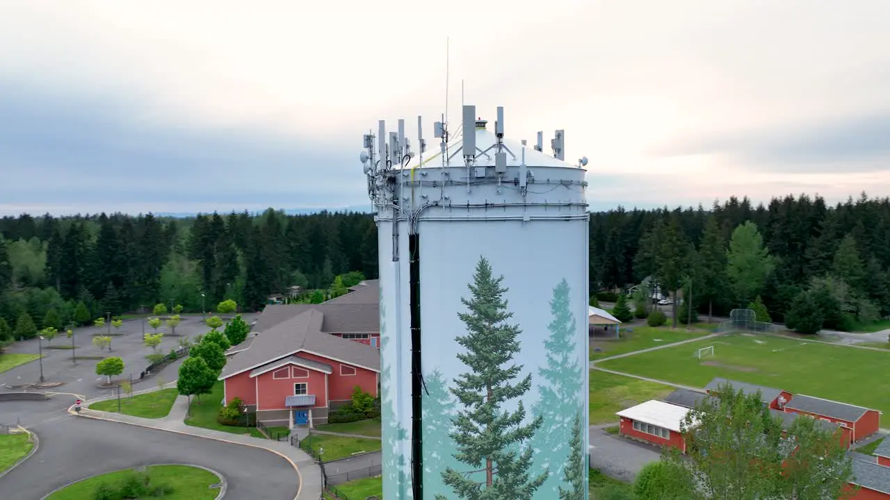 Drone shot of a water tower with technology mounted to the top for broadcasting