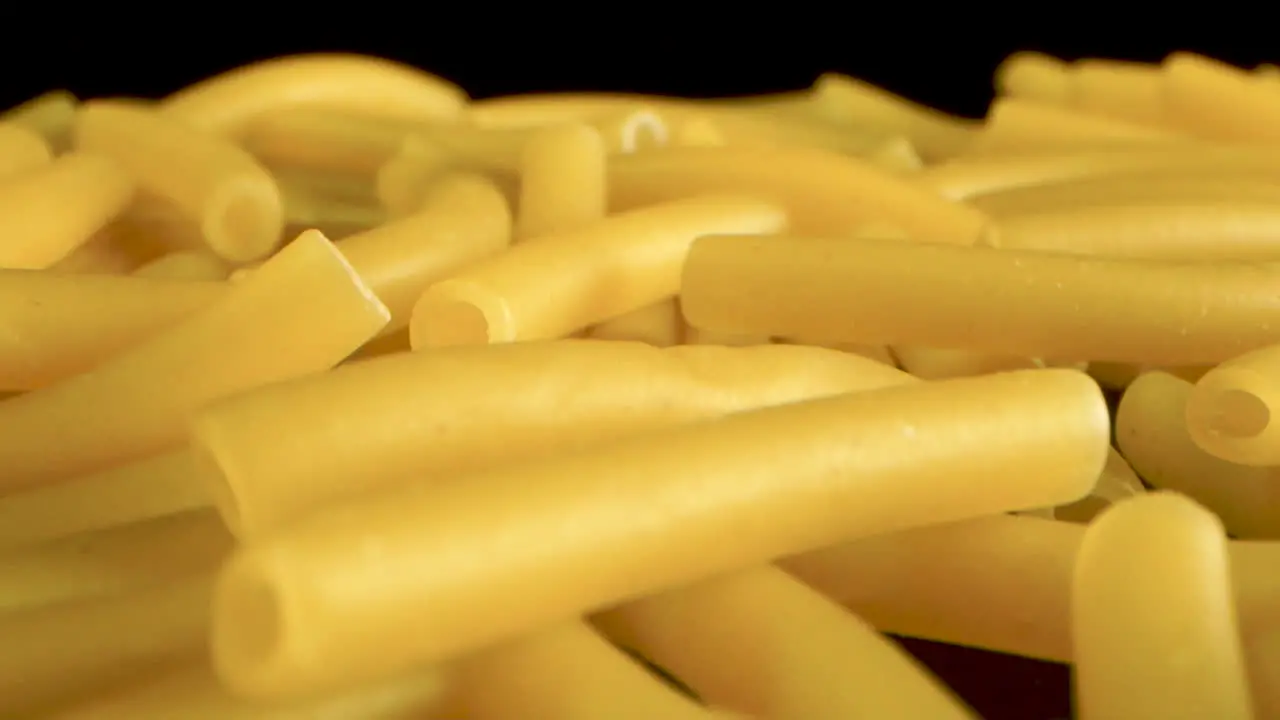 Macro sliding Shot Of macaroni on black table