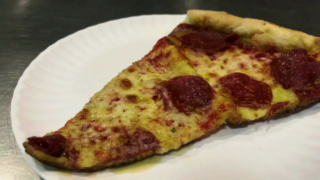 Pizza With Pepperoni Served on Metal Counter Top Close Up