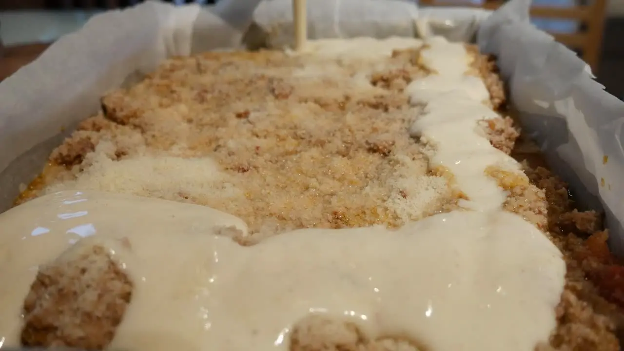 lasagne assembly adding bechamel sauce